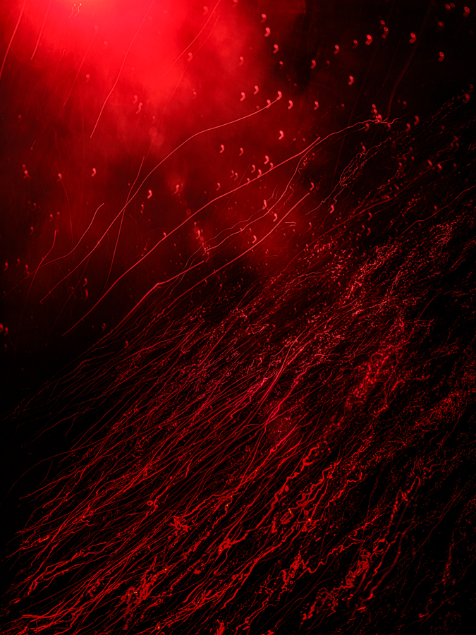 This photograph captures the beauty and violence of the ocean's depths, influenced by the emotions of devastation of the war in Ukraine. Taken during a night scuba dive, the moving water and air bubbles evoke a sense of both tranquility and destruction, much like the human experience.The red is a powerful symbol of the human toll of war and violence, urging us to take action and protect the fragility of our world.